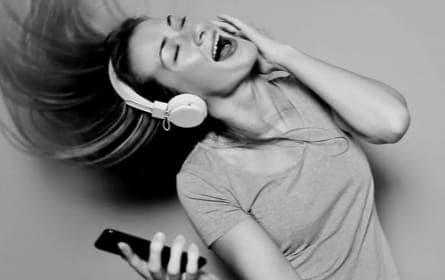 Woman wearing XX599 headphones and dancing.